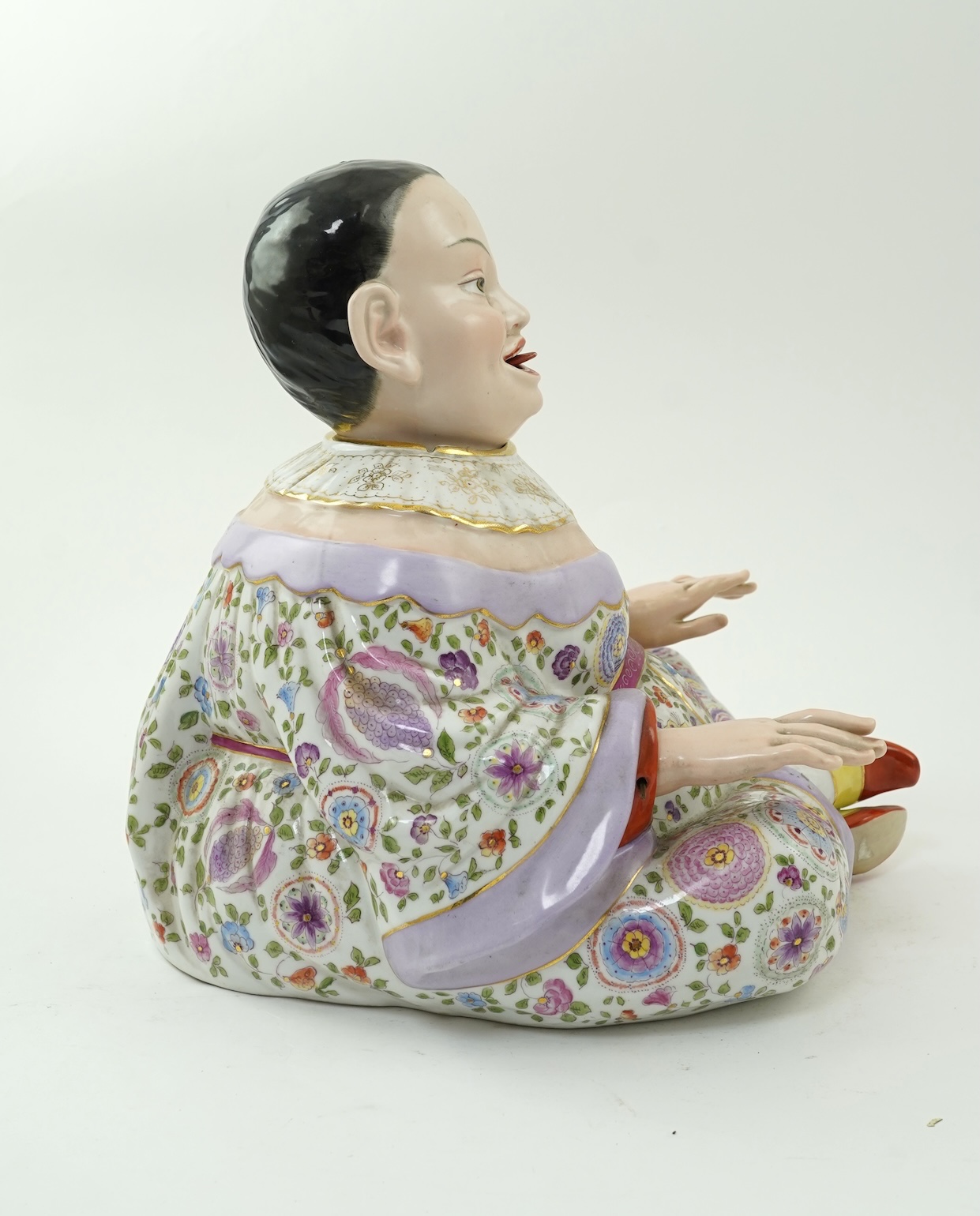 A large Continental porcelain figure of a seated nodding Buddha, early 20th century